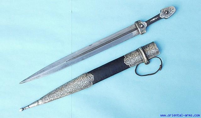 Caucasian qama or kindjal dagger, the 15cm pointed double edged blade with  centre fuller and two-piece horn grip; in nickel plated scabbard with  panels of figures and script L28.5cm overall; and east 